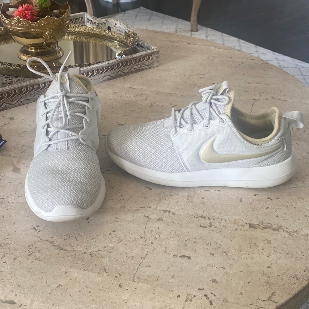 White and gold Nike shoes
